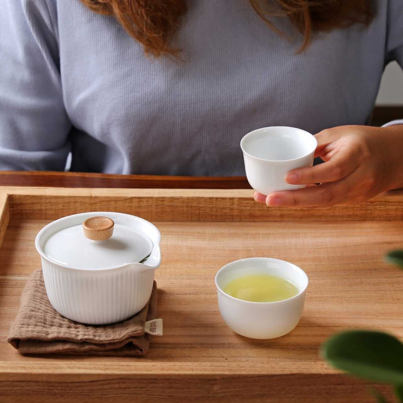 A person enjoying tea in Gaiwan Tea Set - Small Portable Design
